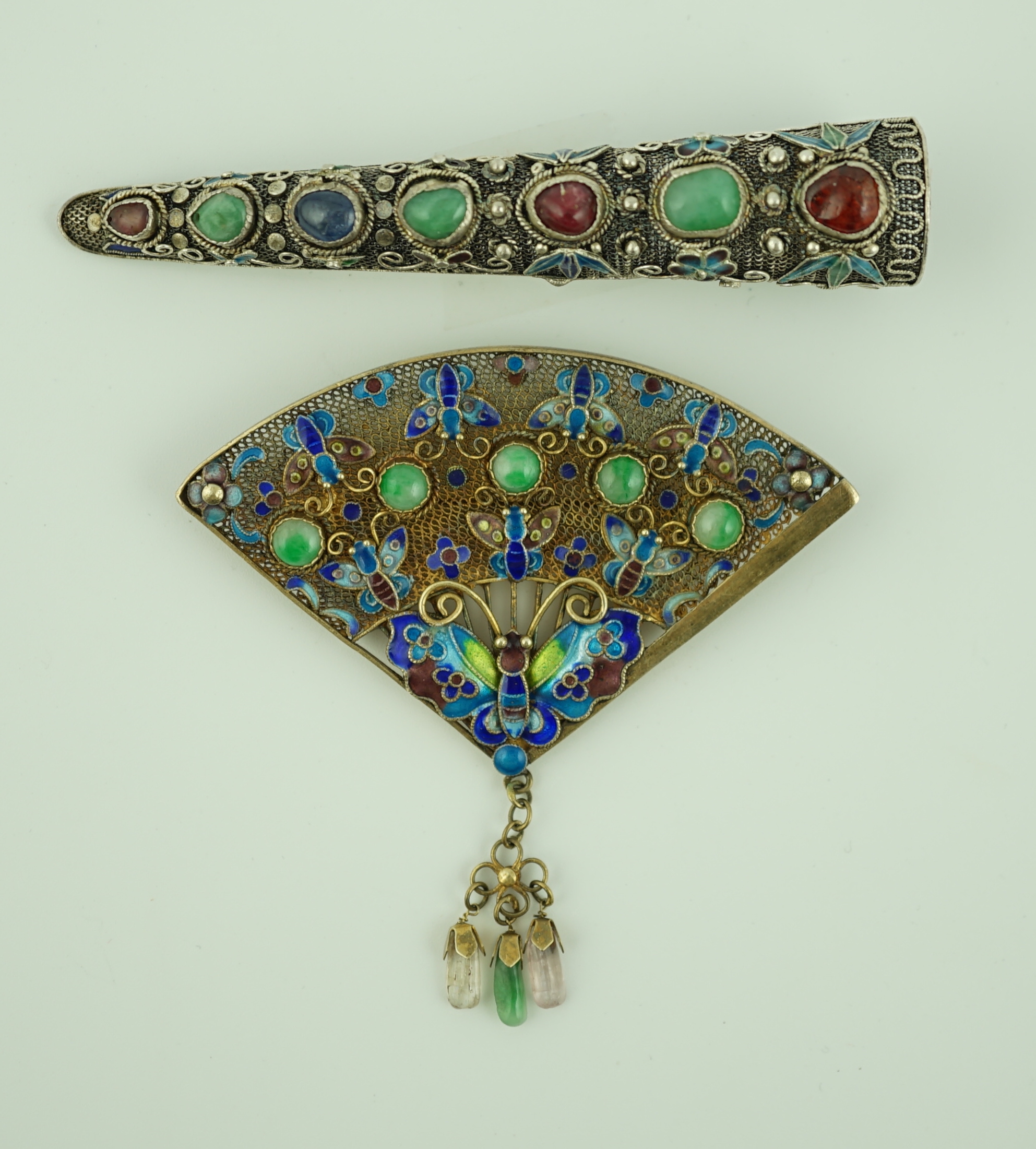 A Chinese silver, enamel and jadeite 'fan' brooch, width 69mm and a similar nail guard brooch, 87mm